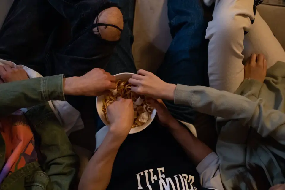 A veterinarian gently palpating a dog's abdomen during a wellness exam