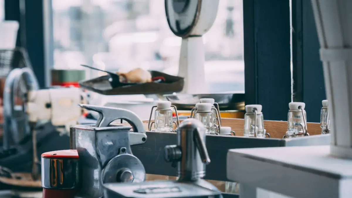 Several dog supplement bottles lined up next to a measuring scoop on a countertop